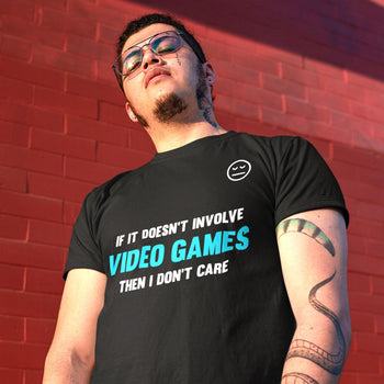 Man with sarcastic t-shirt saying 'If it doesn’t involve video games then I don’t care', and an uninterested face emoticon.