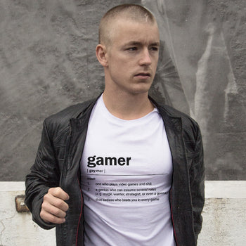 Guy wearing funny gaming t-shirt that gives several amusing definitions of a 'Gamer' in dictionary style design.
