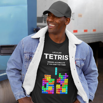 Gamer wearing gaming tee with Tetris elements text saying 'Life is like Tetris, errors accumulate if you don’t fix them'.