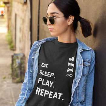 Girl wearing stylish gamer t-shirt that says 'Eat. Sleep. Play. Repeat.', paired with corresponding signage icons.