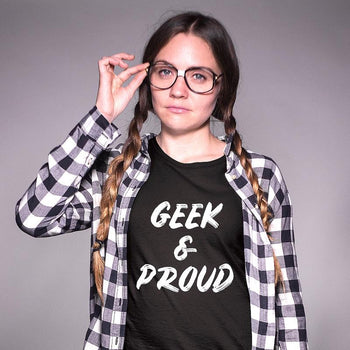 Nerdy girl with glasses wearing a geeky t-shirt that says 'Geek & Proud'.