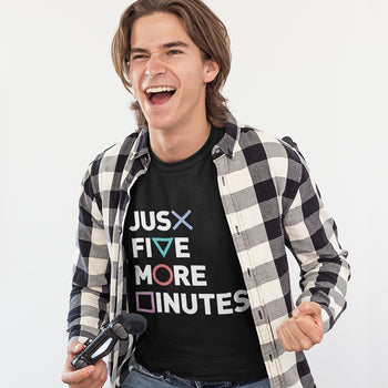 Gamer guy with gaming t-shirt saying 'Just Five More Minutes' and PS controller shapes of cross, triangle, circle and square.